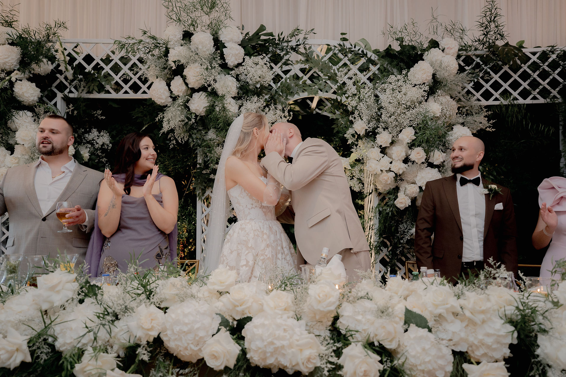 Kinga and Piotr laughing with their bridesmaids and groomsmen during the cocktail hour.