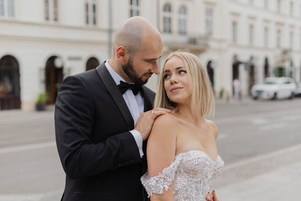 Bride Natalia in her wedding dress with groom Sebastian in outdoor portrait